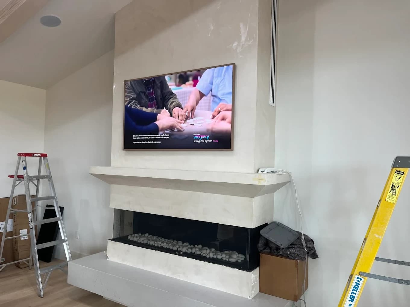 TV mounted above modern fireplace with hidden wiring